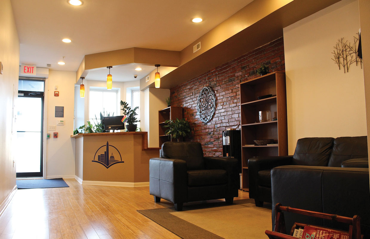 Warm toned wood floors and brick walls soothe customers at the front desk of Capital City Care at the Washington D.C. dispensary.