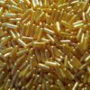 A pile of golden cannabis 00 capsules made by God Med