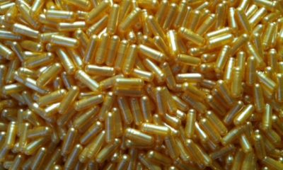 A pile of golden cannabis 00 capsules made by God Med