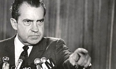 A black and white image of Richard Nixon at a press conference selecting a member of the press to ask a question about his opinion on marijuana, a substance which he hated.