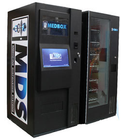 A large, black vending machine reading MDS, made by MedBox, one of the highest earning stocks in the cannabis industry.