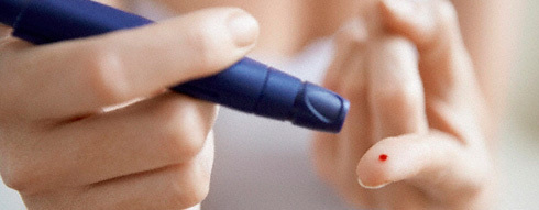A diabetic pricks fingertip with blood glucose meter, which can be evened out with marijuana.