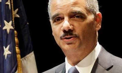 Former AG Eric Holder stands by an American flag as he assures his public that an answer to marijuana is coming.