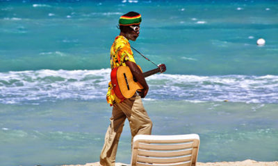 A beachcomber on the sands of Jamaica, a great spot for a marijuana vacation.