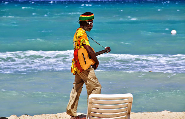 A beachcomber on the sands of Jamaica, a great spot for a marijuana vacation.