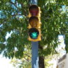 A green light on a stop light shows through a pot leaf stencil.