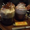 Two coffee drinks piled with whipped cream sit next to a joint and lighter at the new The White Horse Inn of Del Norte, Colorado.