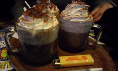 Two coffee drinks piled with whipped cream sit next to a joint and lighter at the new The White Horse Inn of Del Norte, Colorado.