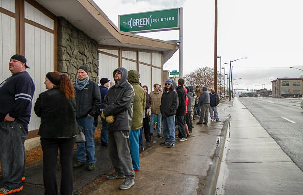Hundreds of customers wait in line at The Green Solution in Denver to open its doors Wednesday January 1, 2014. Colorado is the first state in the U.S. to allow recreational use of cannabis to adults over the age of 21. Photo by Courtland Wilson/ Cannabis Now Magazine