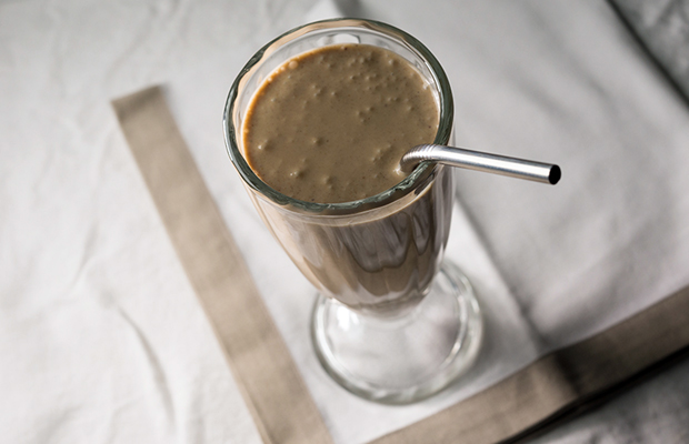 A shake glass filled with a medicated date smoothie.