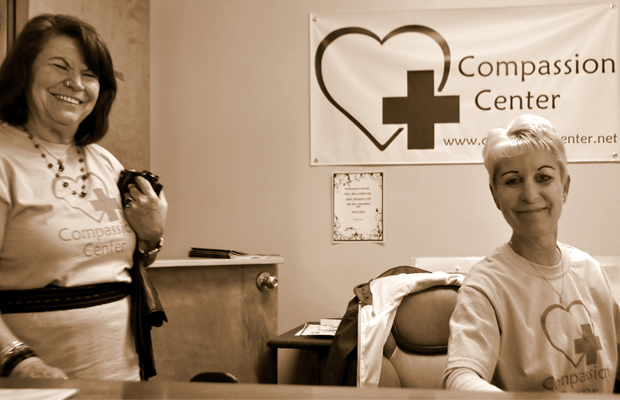 Receptionists sit at their desks at the Compassion Center in Eugene OR.