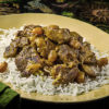 An edible dish of curried cannabis lamb on a bed of rice.
