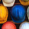 Red, blue, white, and yellow hard hats represent the hardworking blue collar class