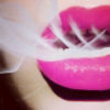 A woman with bright pink lips exhales a hit from marijuana, which allows her to have a better sex life.