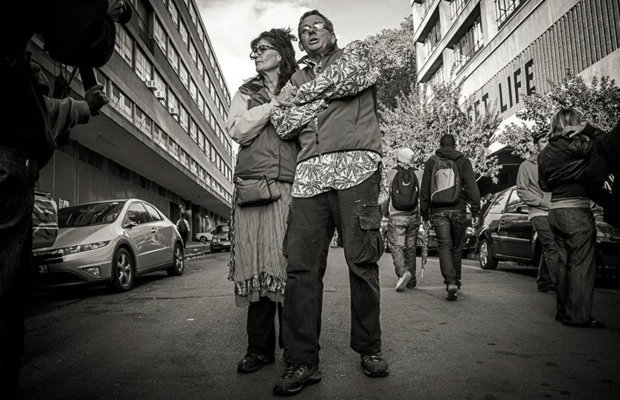 Julian “Jules” Stobbs and Myrtle Clark stand in a street for a black and white picture with arms crossed as they get ready to sue South Africa for raiding their grow.
