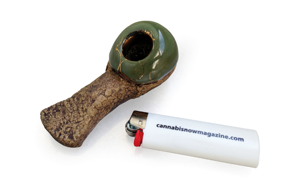 A Celebration Pipe, made of Hawaiian lava rock and plated around the bowl with 22-karat gold, next to Cannabis Now lighter, waiting to be smoked when pot is legalized.