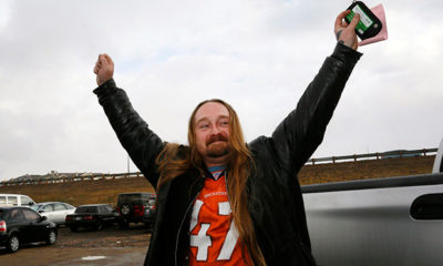Jesse Phillips celebrates being the first person to legally buy recreational marijuana (in his left hand) at the BotanaCare store in Northglenn, Colorado, on Jan. 1, 2014.