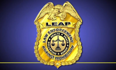 A LEAP (Law Enforcement Against Prohibition) badge against a blue background.