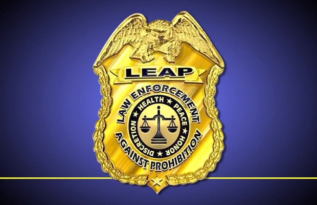 A LEAP (Law Enforcement Against Prohibition) badge against a blue background.