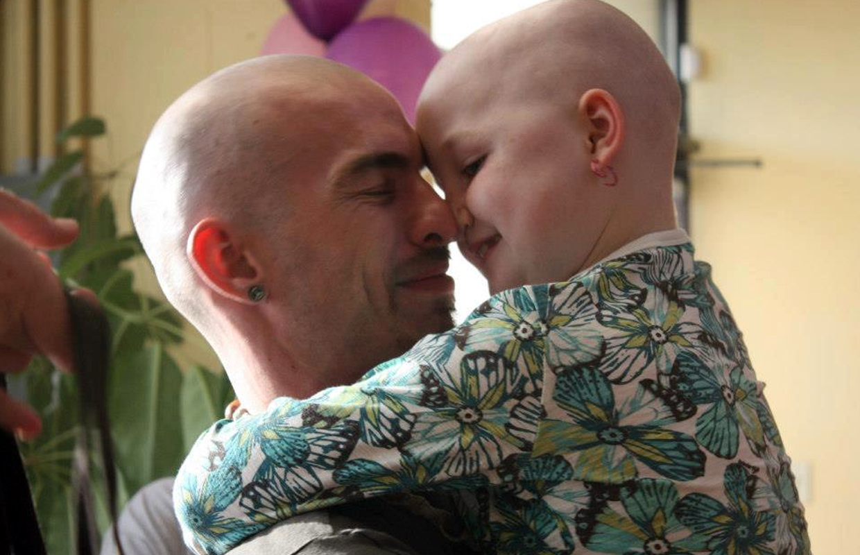 Brandon holds his daughter Mykayla, who uses CBD oils to treat her cancer.