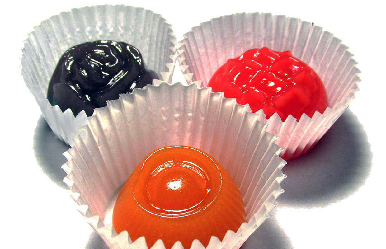 Brightly colored Bhomb Jellies infused with cannabis sit in individual cups.