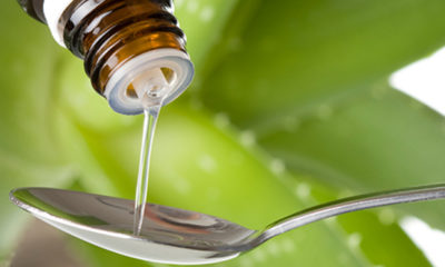 CBD oil pours out into a spoon as more and more states sign CBD only laws.