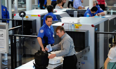 A passenger goes through security at the Denver airport with new clarified rules for traveling with cannabis.