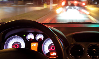A view of a road at night from the interior of a vehicle where the driver is high.