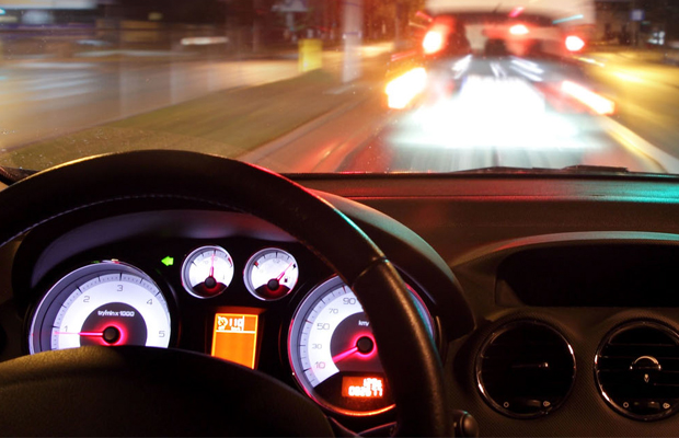 A view of a road at night from the interior of a vehicle where the driver is high.