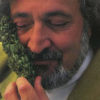 Jack Herer, the godfather of the modern hemp legalization movement, holds a large bud up to his face and inhales the beautiful scent with a smile on his face.