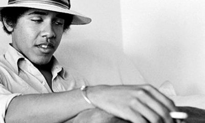 A black and white image of young Barack Obama in a fedora holds a joint in his hand.