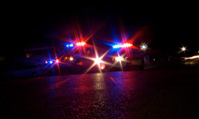 Red and blue police lights flash in the night for crimes not cannabis related.