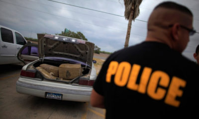 A police officer next an opened trunk car has been ordered to give back confiscated marijuana.