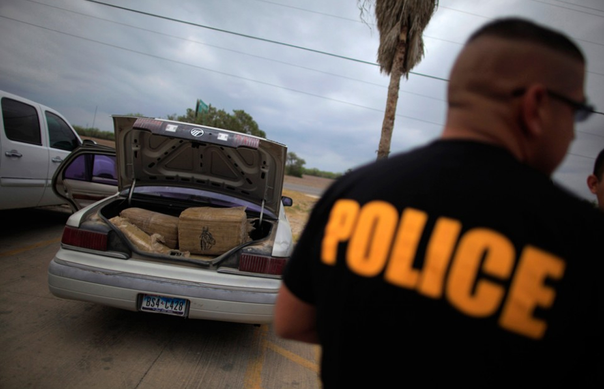 A police officer next an opened trunk car has been ordered to give back confiscated marijuana.