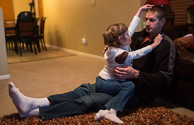 Mark Botker plays with daughter Greta, 7, at their new Colorado home. Greta joined a migration of parents who, after trying countless methods to ease their children's crippling seizures, are packing up their families and moving to Colorado.