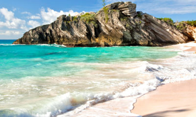 Clear waters roll onto a beach in Bermuda where cannabis laws may be relaxed.