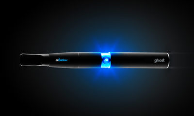 A Dr. Dabber vapor pen glows blue against a dark background.