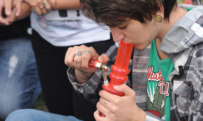 A young man smokes marijuana during the World Day for the Legalization of Marijuana on May 3, 2014 in Montevideo.