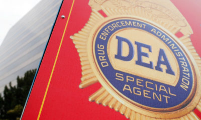 A red DEA special agent truck is parked.