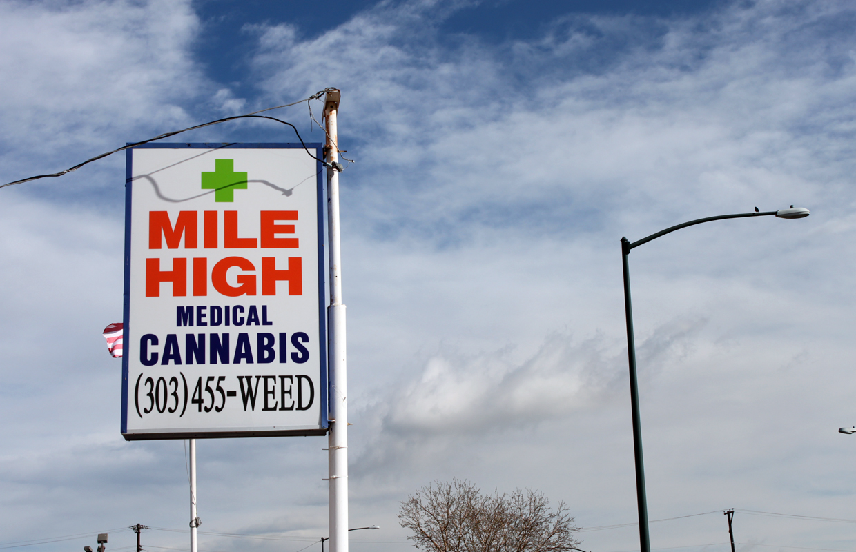 A street sign directs patients and customers to the Mile High Medical Cannabis Club near Denver, CO.