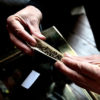 A worker rolls up a joint as he heads to work in Uruguay, where smoking on the job is legal.