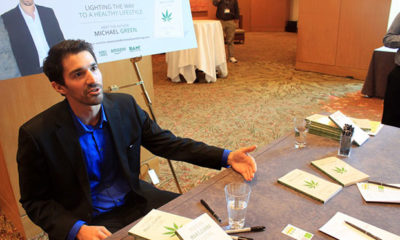 Author Michael Green talks with passersby about his book "Marijuana Living" at the first annual Weedstock Conference in Denver