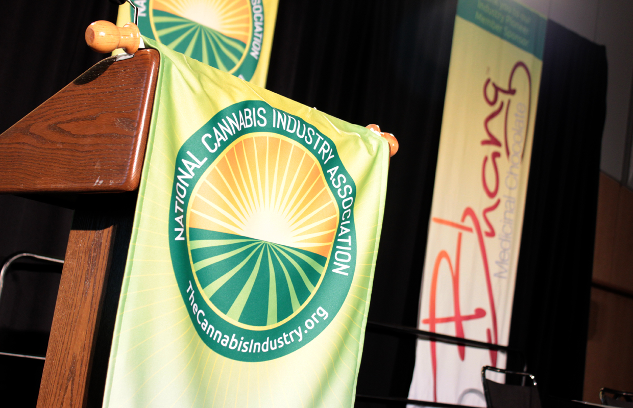 A National Cannabis Industry and Association banner covers the front of a podium at the Denver expo in July, 2014.