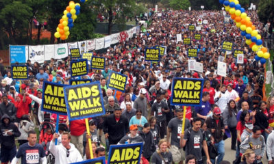 Hundreds of people march down a street holding 'AIDS Walk' signs in San Francisco, where the marijuana and AIDS communities have deep roots together.