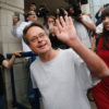 Marc Emery waves at the press as he is released from a U.S. prison to Canada as a free man.