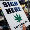 A poster urges Orgonien voters to "sign here" in favor of Measure 91, which would allow adults to partake in legalized recreational marijuana.