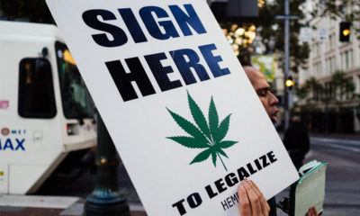 A poster urges Orgonien voters to "sign here" in favor of Measure 91, which would allow adults to partake in legalized recreational marijuana.