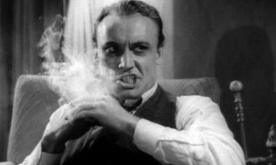 A black and white still from the 1930s movie "Reefer Madness" shows a man smoking marijuana and going insane.