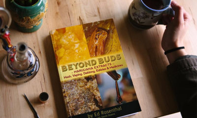Ed Rosenthal's "Beyond Buds" sits on a table with a cup of coffee, snacks, and a dab rig.