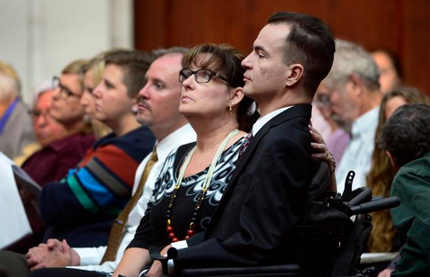 Brandon Coats, right, waits for the proceedings to begin with his mother Donna Scharfenberg sitting by his side.